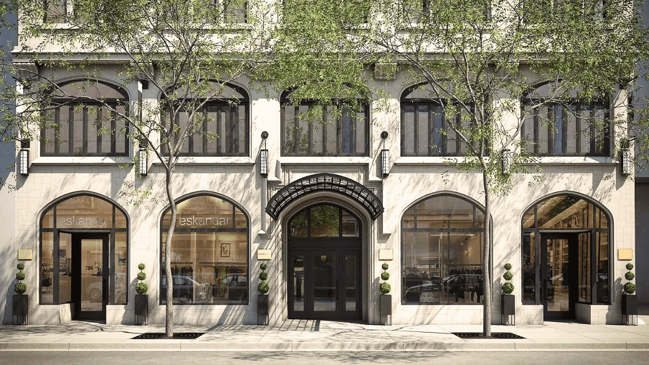 Elegant building facade with large arched windows and greenery outside.